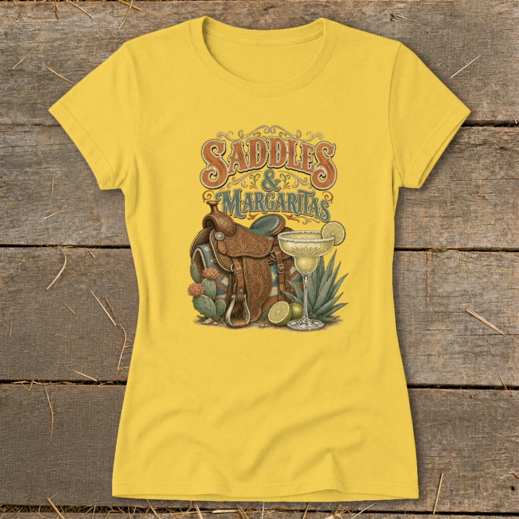 Yellow t-shirt with "Saddles & Margaritas" graphic featuring a saddle, margarita, and cacti.