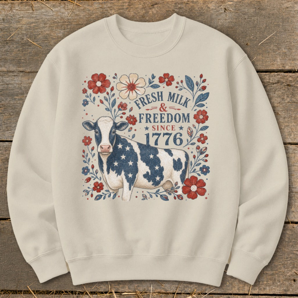Cream sweatshirt with cow, stars, and text: Fresh Milk & Freedom Since 1776.