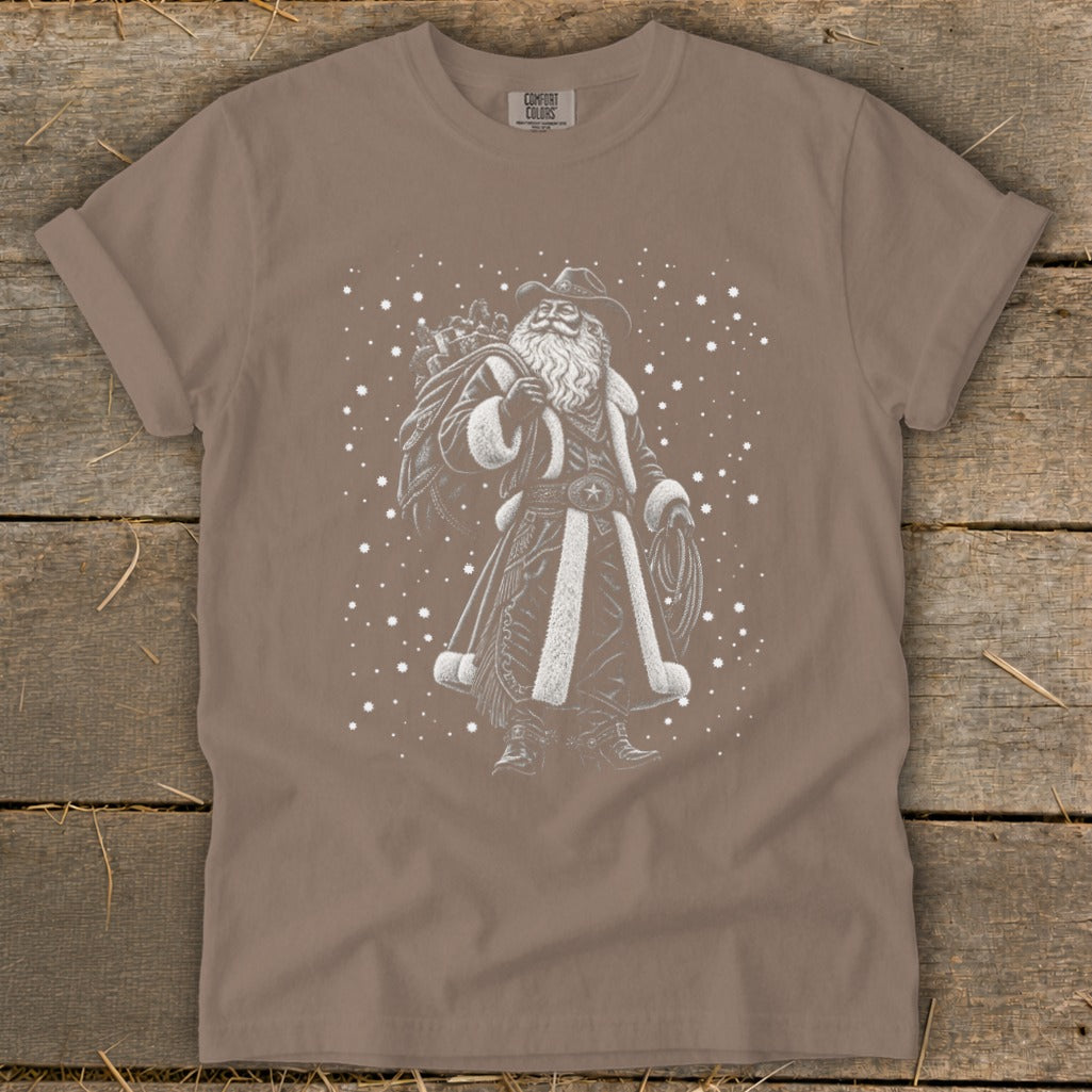 Cowboy Santa illustration with sack of gifts and lasso on a taupe t-shirt.