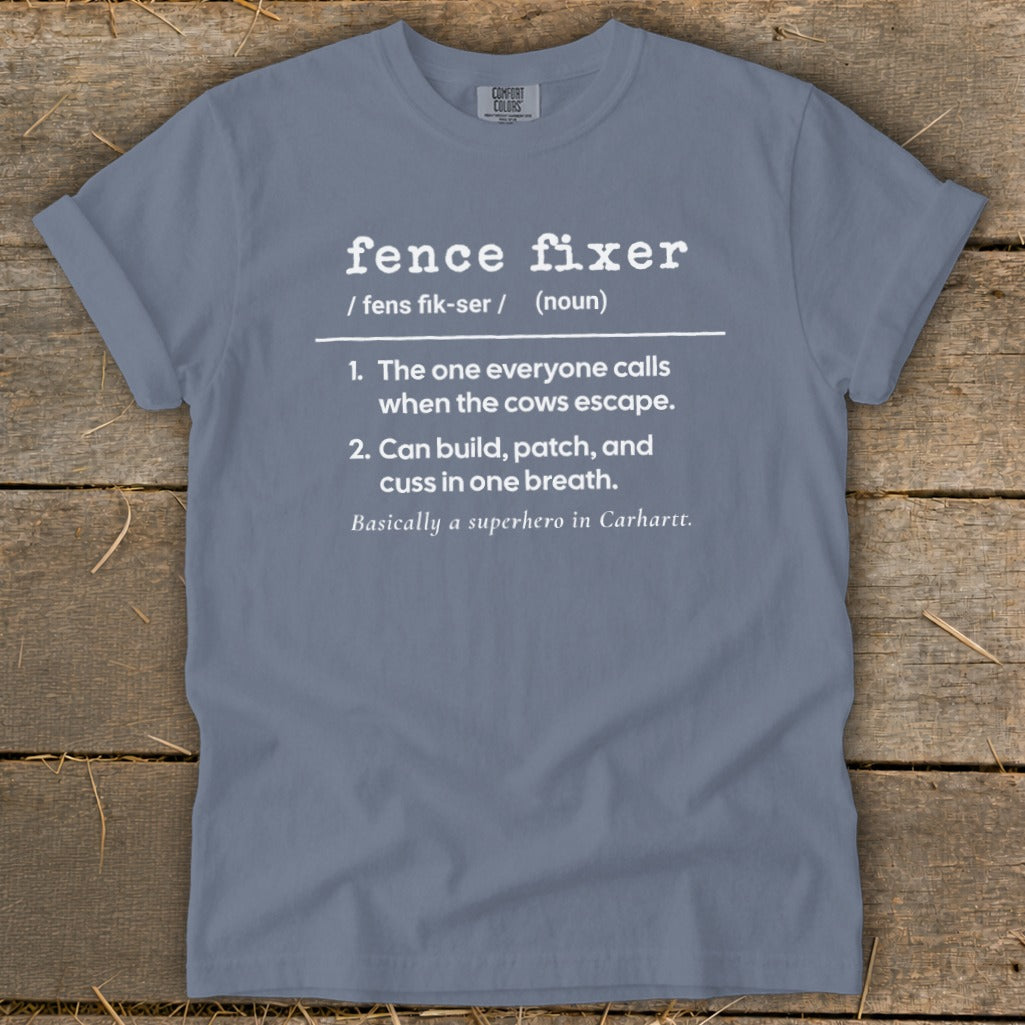 Gray t-shirt with "fence fixer" definition including humor about cows escaping.