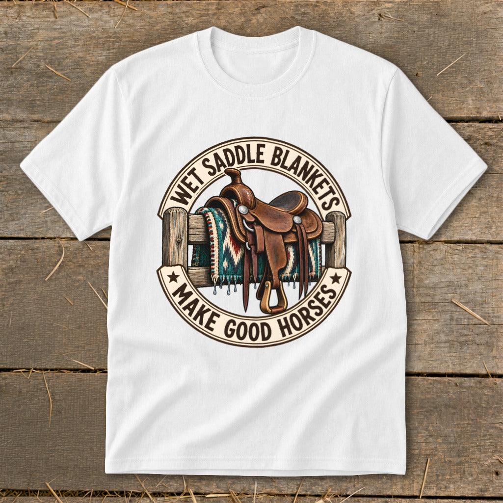 White t-shirt featuring a circular graphic with a saddle, fence, and blanket, and text "Wet Saddle Blankets Make Good Horses".