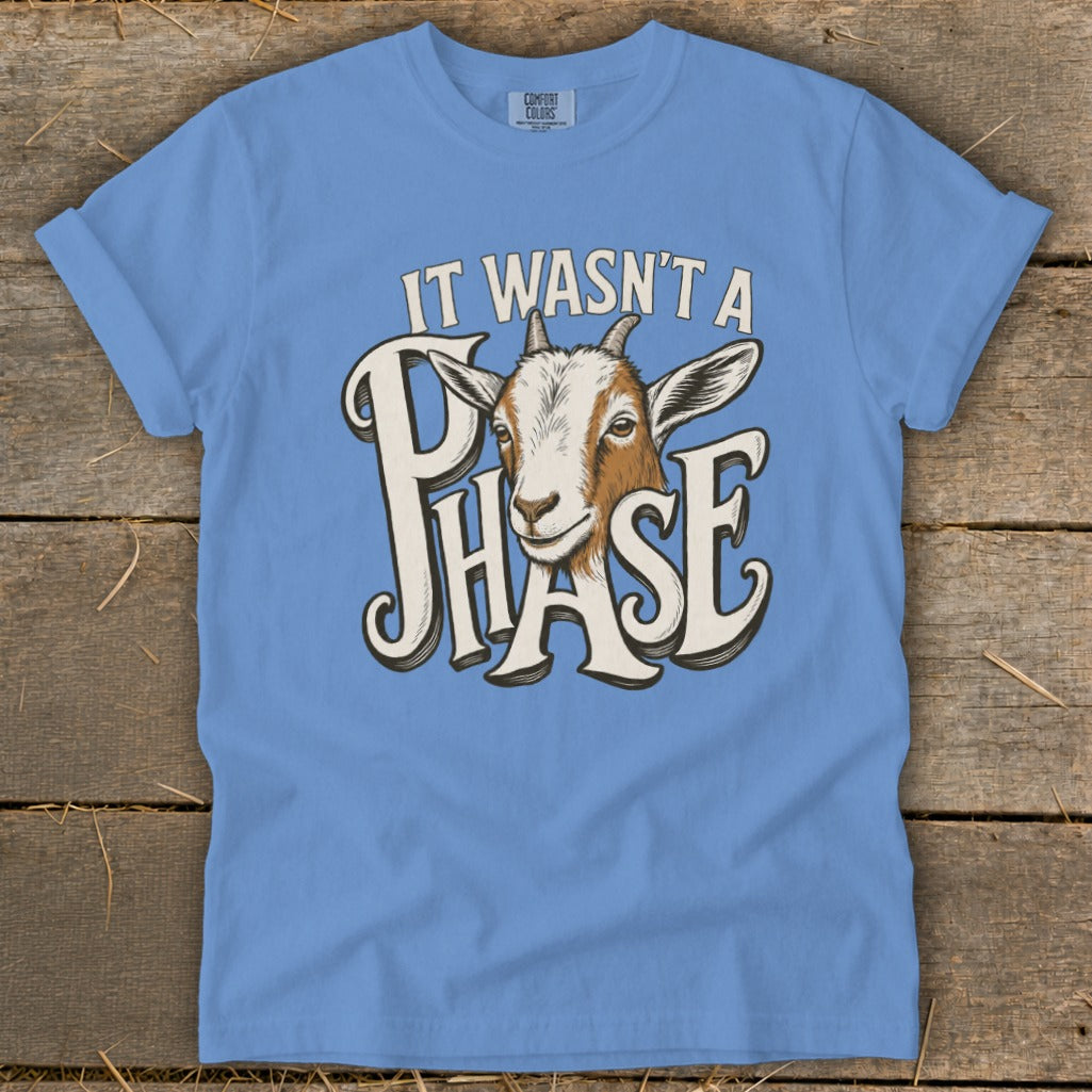Blue t-shirt with goat graphic and text "IT WASN'T A PHASE".