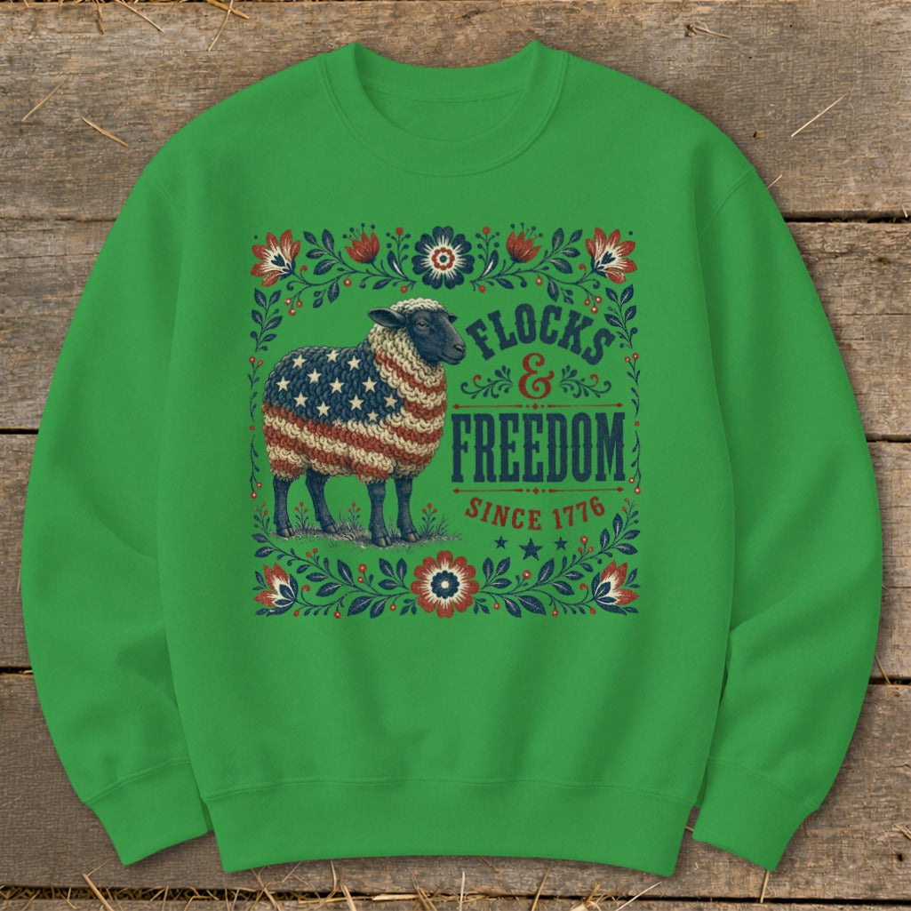 Sheep with American flag pattern on fleece sweater, text "Flocs & Freedom Since 1776".