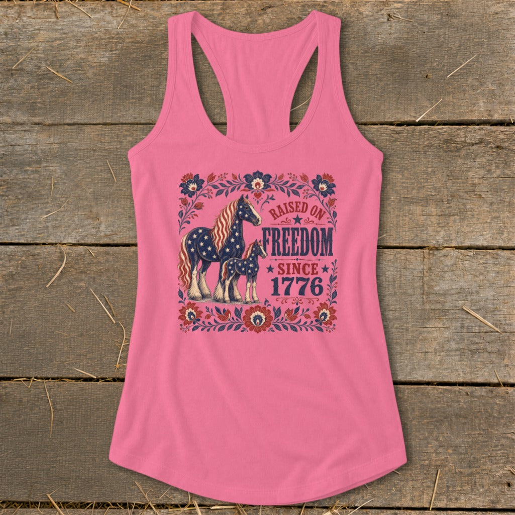 Pink tank top with horses and "Raised on Freedom Since 1776" text.