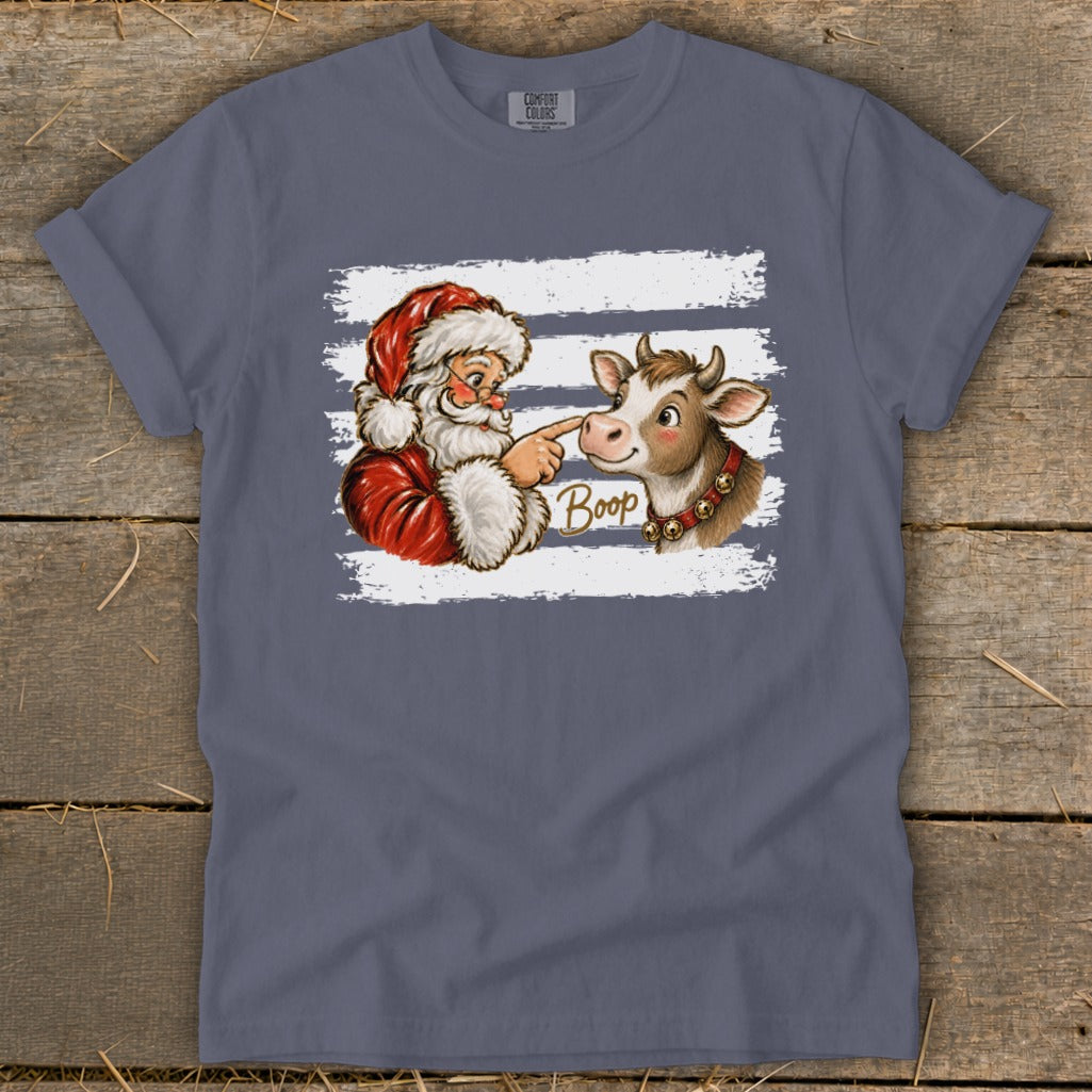 Santa booping a cow with the word "Boop" on a blue t-shirt.