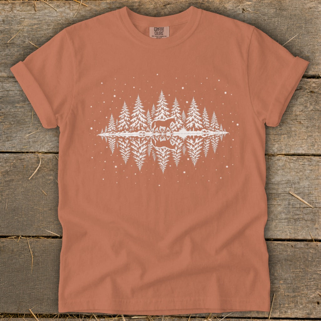 Orange t-shirt with white graphic of horse and trees reflected in water.