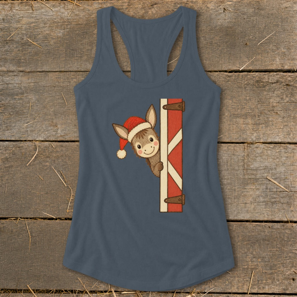 Donkey wearing Santa hat peeking from barn door graphic on a blue tank top.
