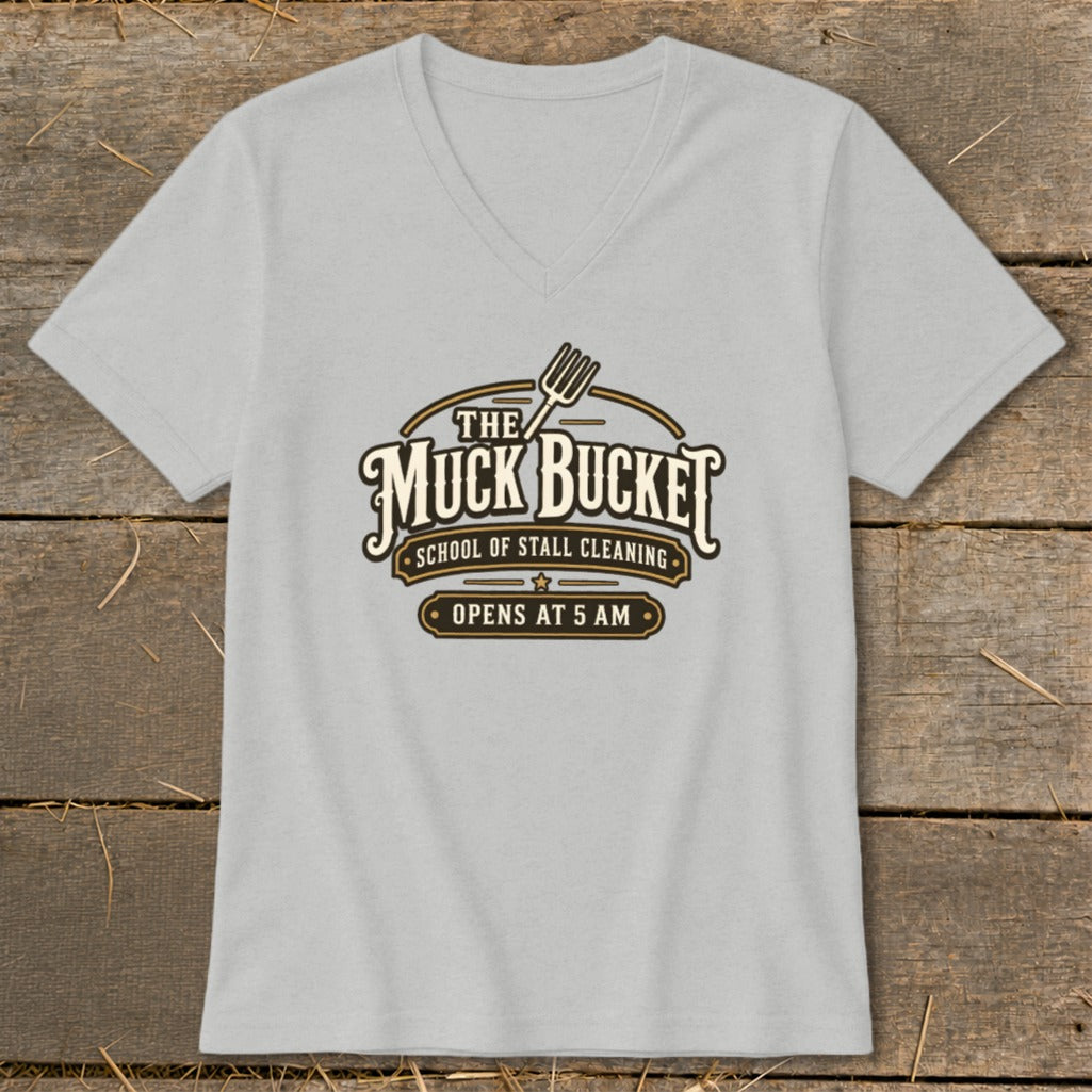Light grey t-shirt with a logo that reads "The Muck Bucket School of Stall Cleaning Opens at 5 AM".