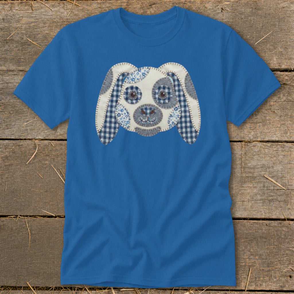 Blue t-shirt with a sewn applique of a dog's face featuring blue and white patterns.