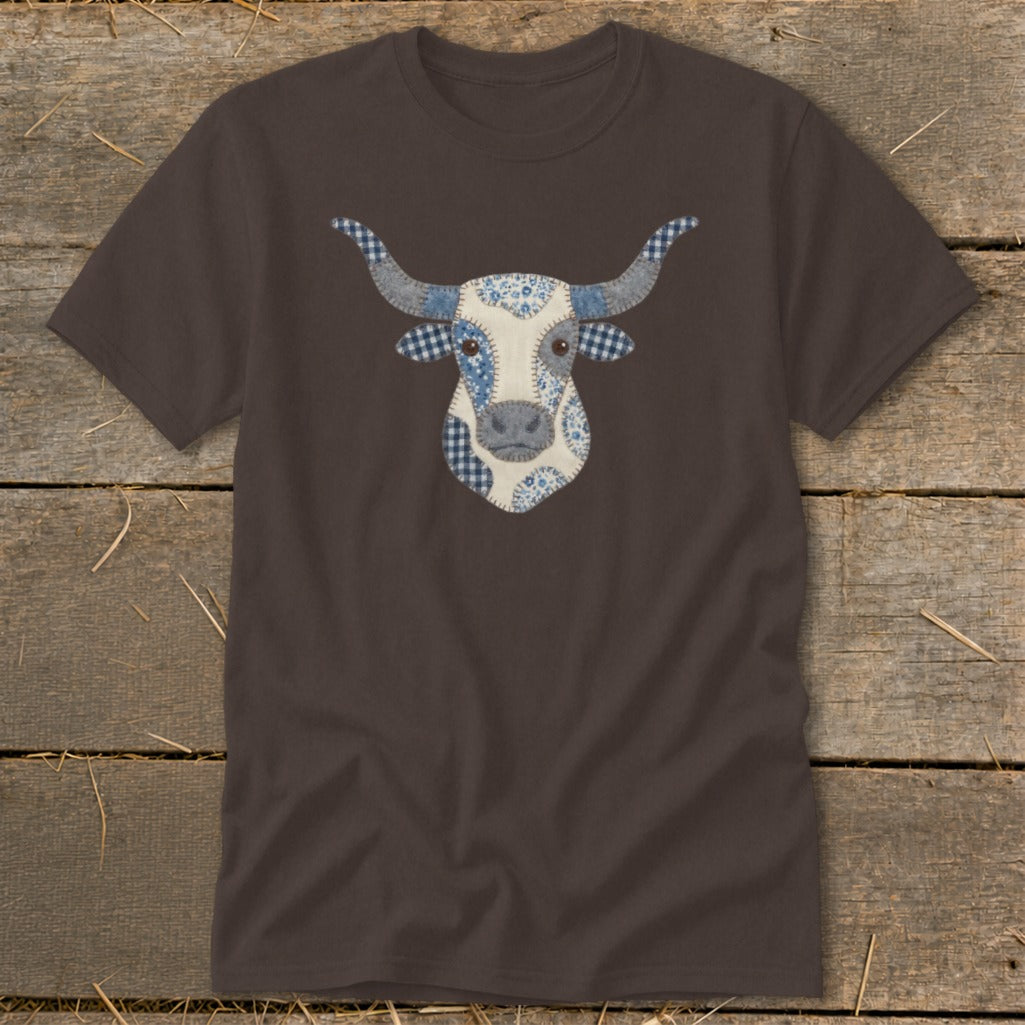 Brown t-shirt with a patchwork cow face design in blue and white fabrics.