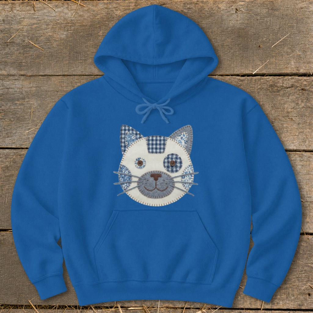 Blue hoodie with a patchwork cat face graphic on the chest.