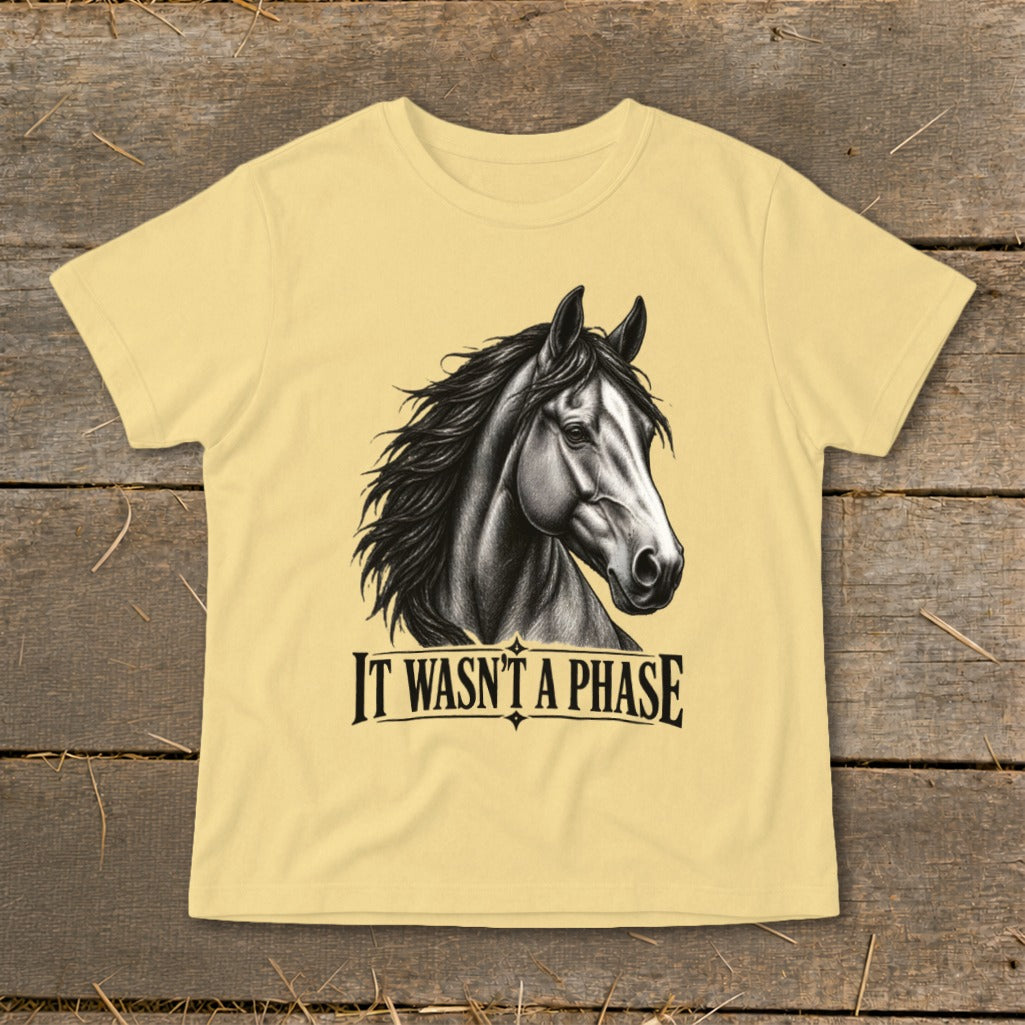 Yellow t-shirt with black horse head and "IT WASN'T A PHASE" text.