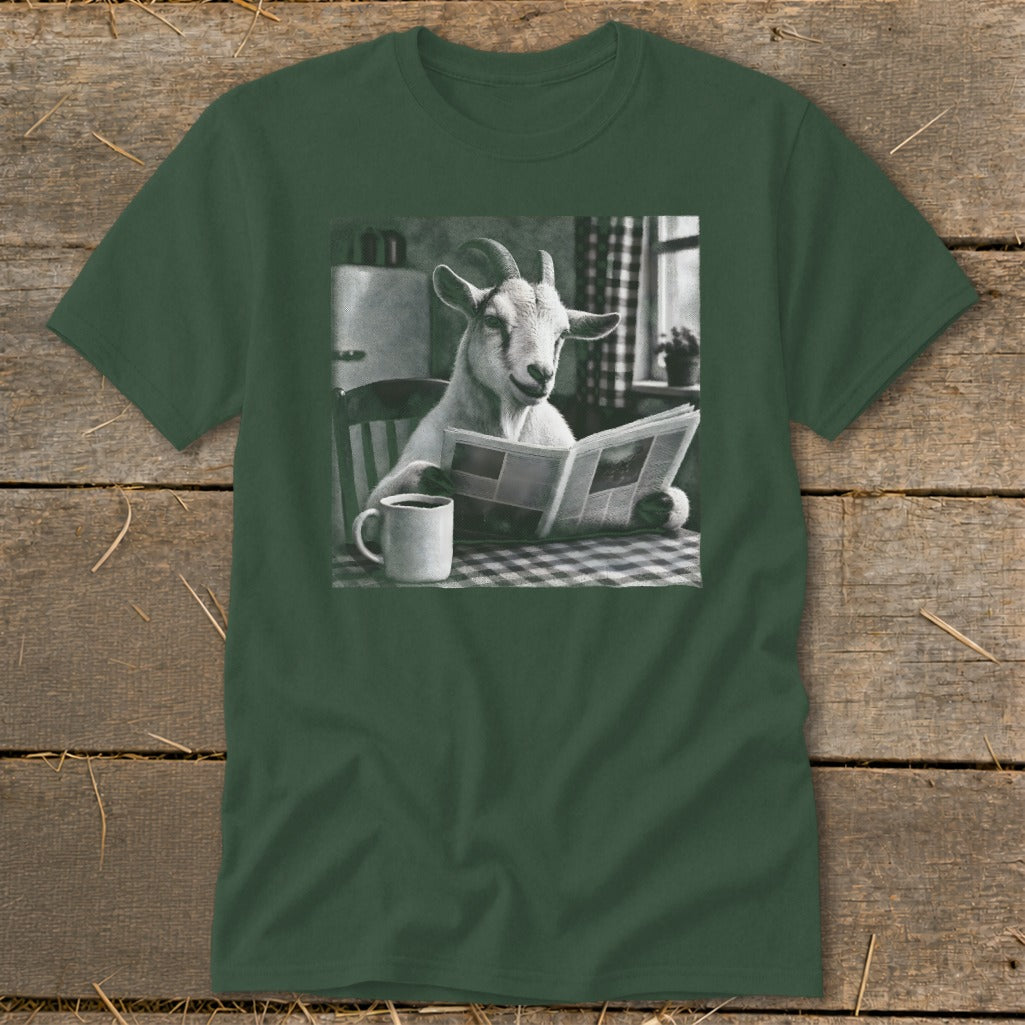 A dark green t-shirt featuring a black and white graphic of a goat reading a newspaper at a table with a mug of coffee.