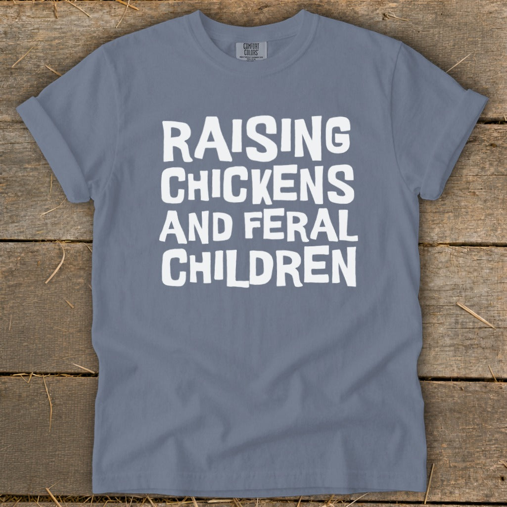 T-shirt with white text "Raising Chickens And Feral Children"