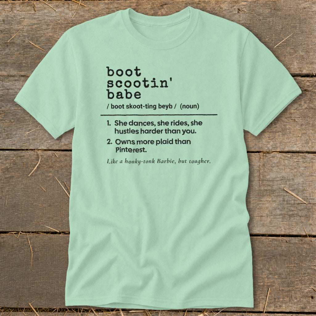 Mint t-shirt with black text defining "boot scootin' babe" and listing characteristics.