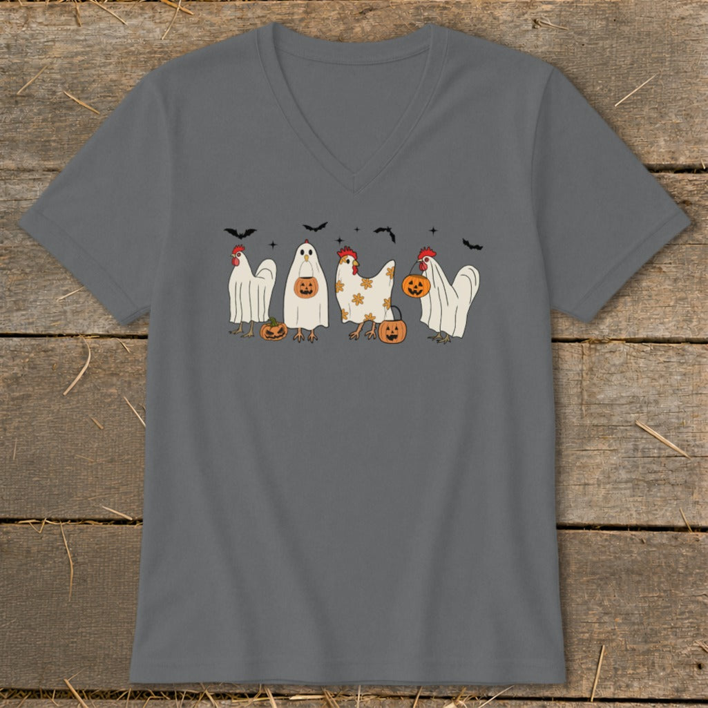 Halloween chickens dressed as ghosts holding pumpkins with bats overhead.