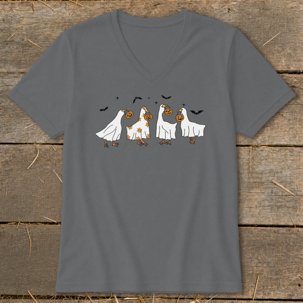 Four ducks dressed as ghosts carry pumpkins, with bats flying around.