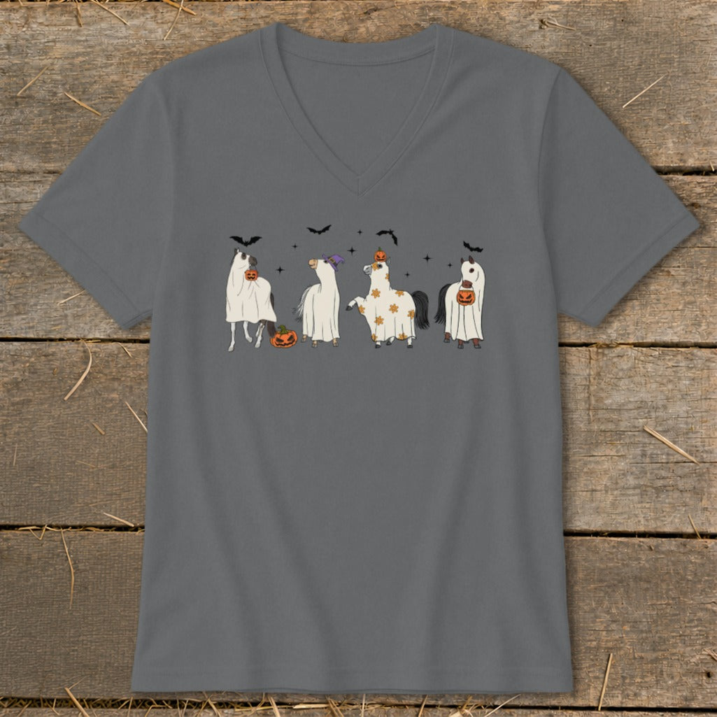 Four horses in Halloween ghost costumes with pumpkins and bats.