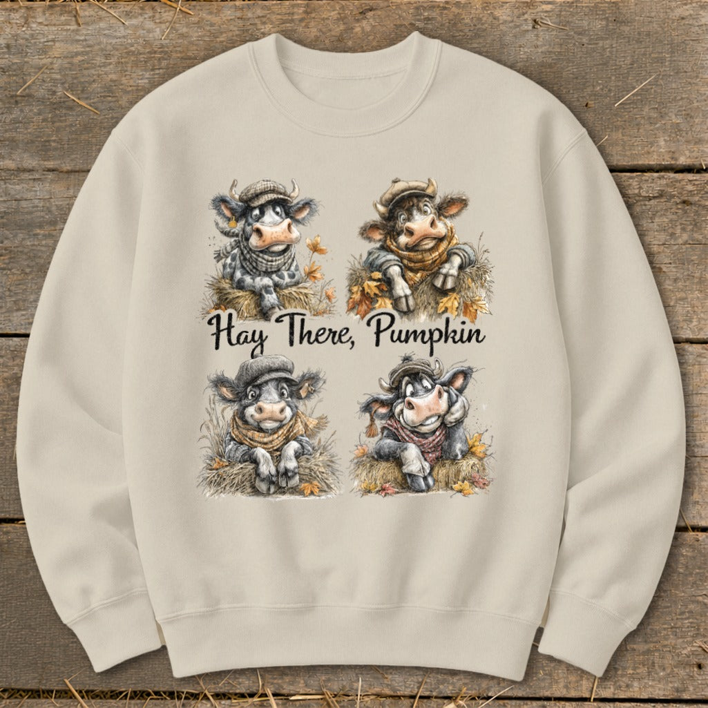 Four cartoon cows in hats and scarves with fall leaves and text "Hay There, Pumpkin".