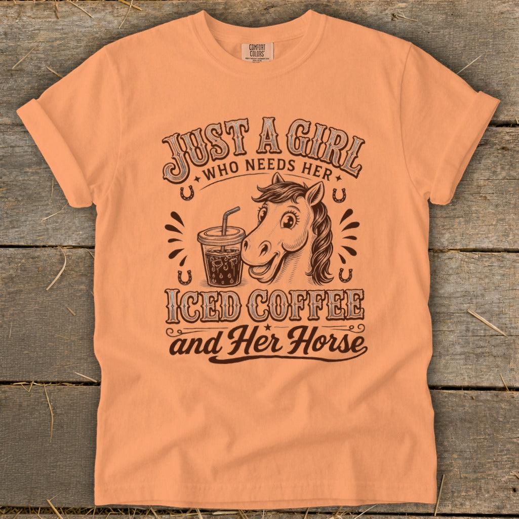 Peach-colored short-sleeve t-shirt with brown text and an illustration of a horse drinking iced coffee.