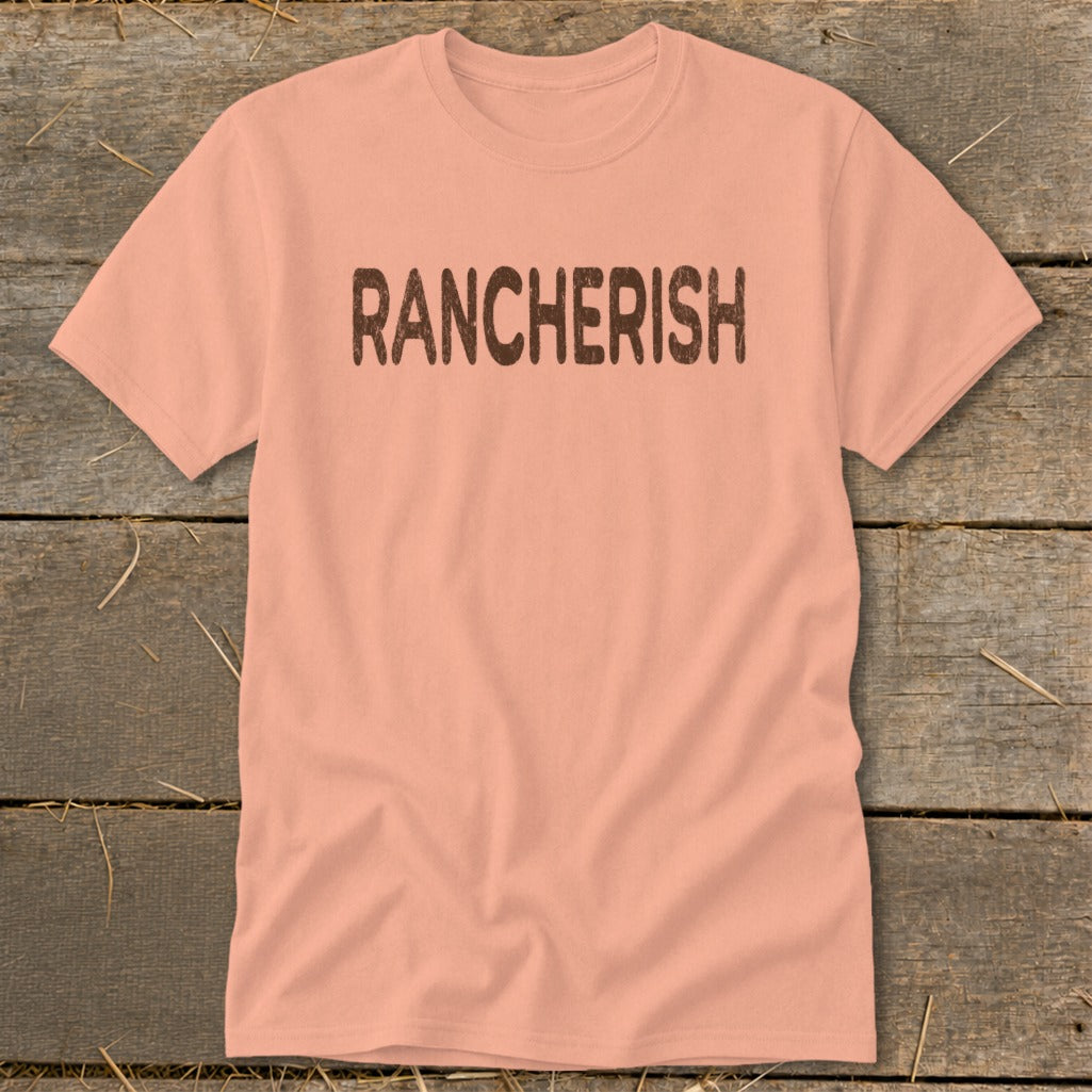 Peach t-shirt with "RANCHERISH" printed in distressed brown letters.