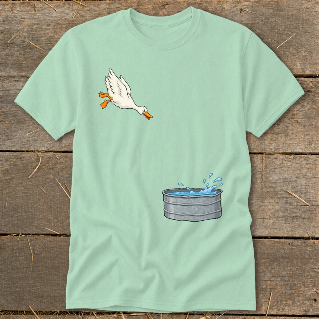 Light blue t-shirt with a cartoon goose jumping towards a galvanized water trough.