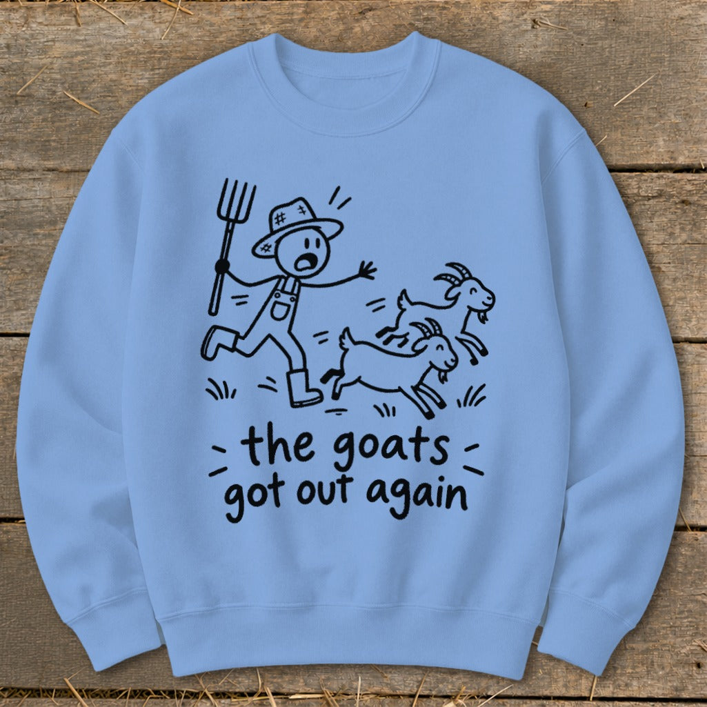 Light blue sweatshirt with cartoon farmer chasing goats and text "the goats got out again".