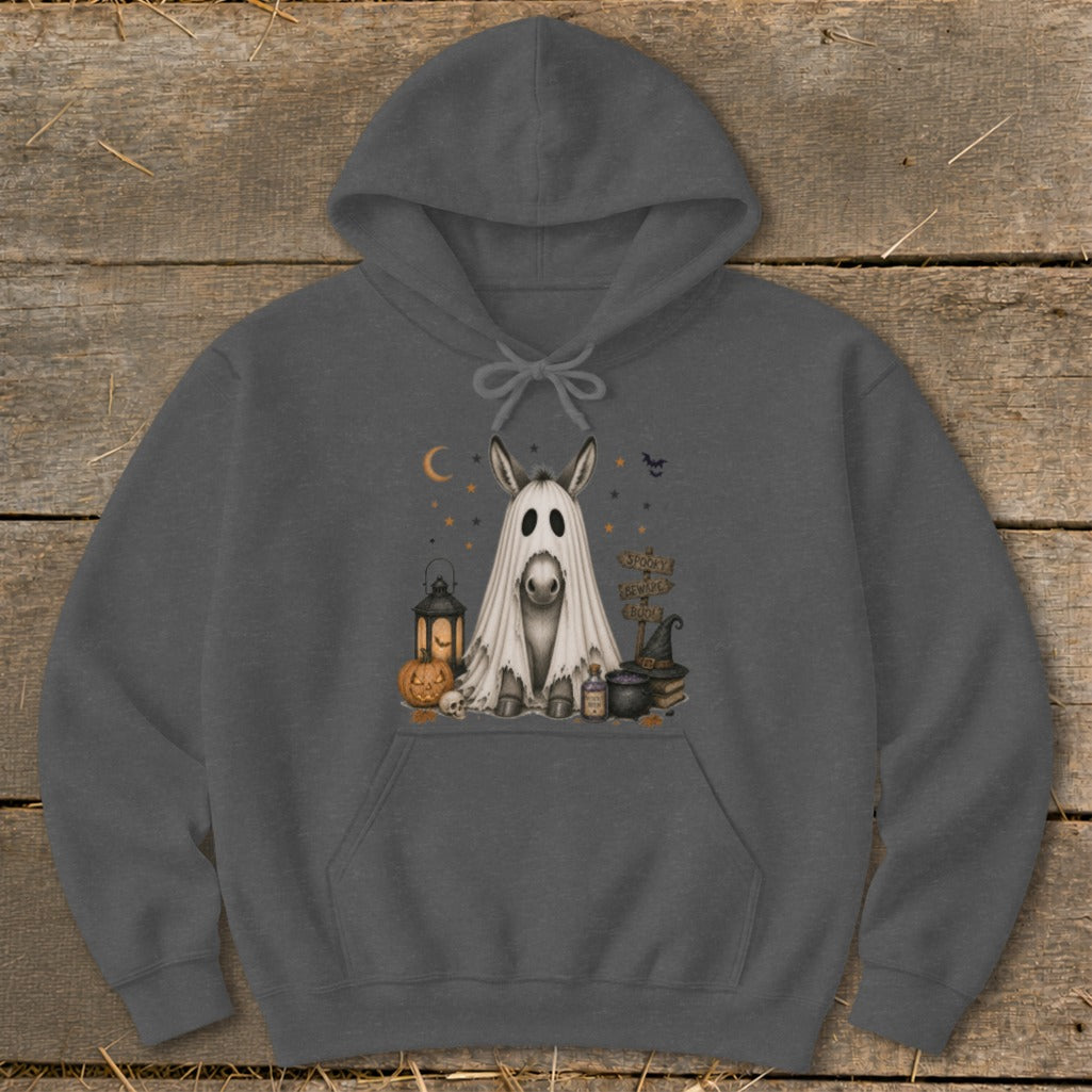 Donkey in ghost costume with Halloween decor and signs.