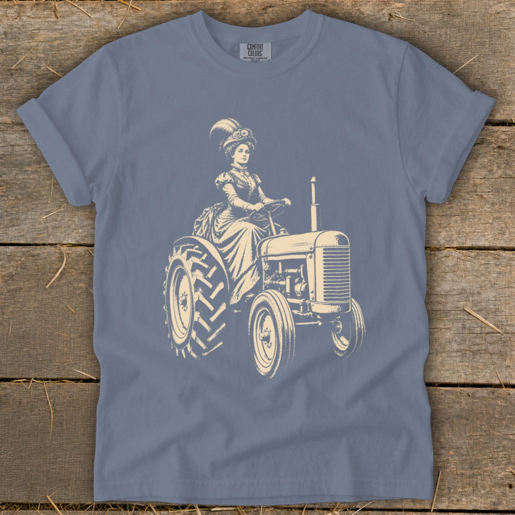 Cream illustration of a woman in a Victorian dress driving a tractor.