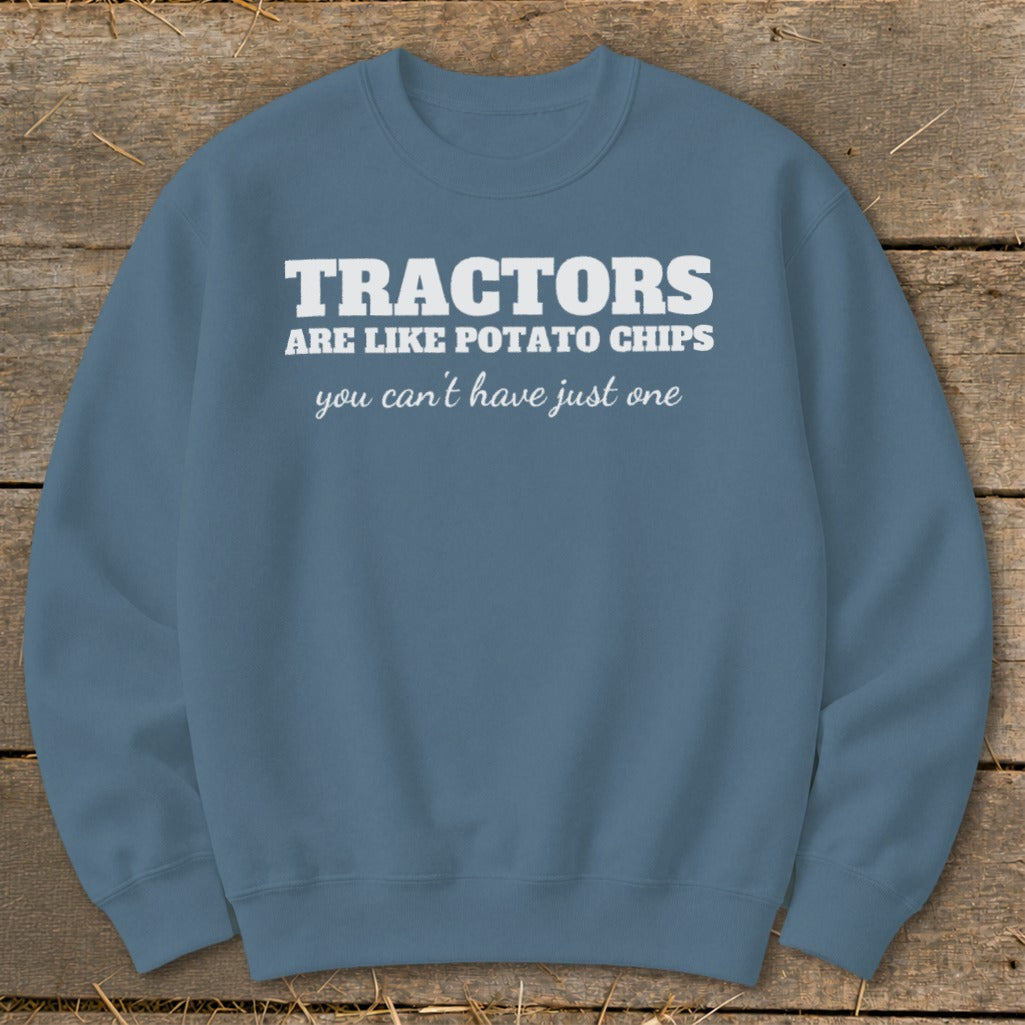 Blue sweatshirt with white text reading "Tractors are like potato chips you can't have just one."