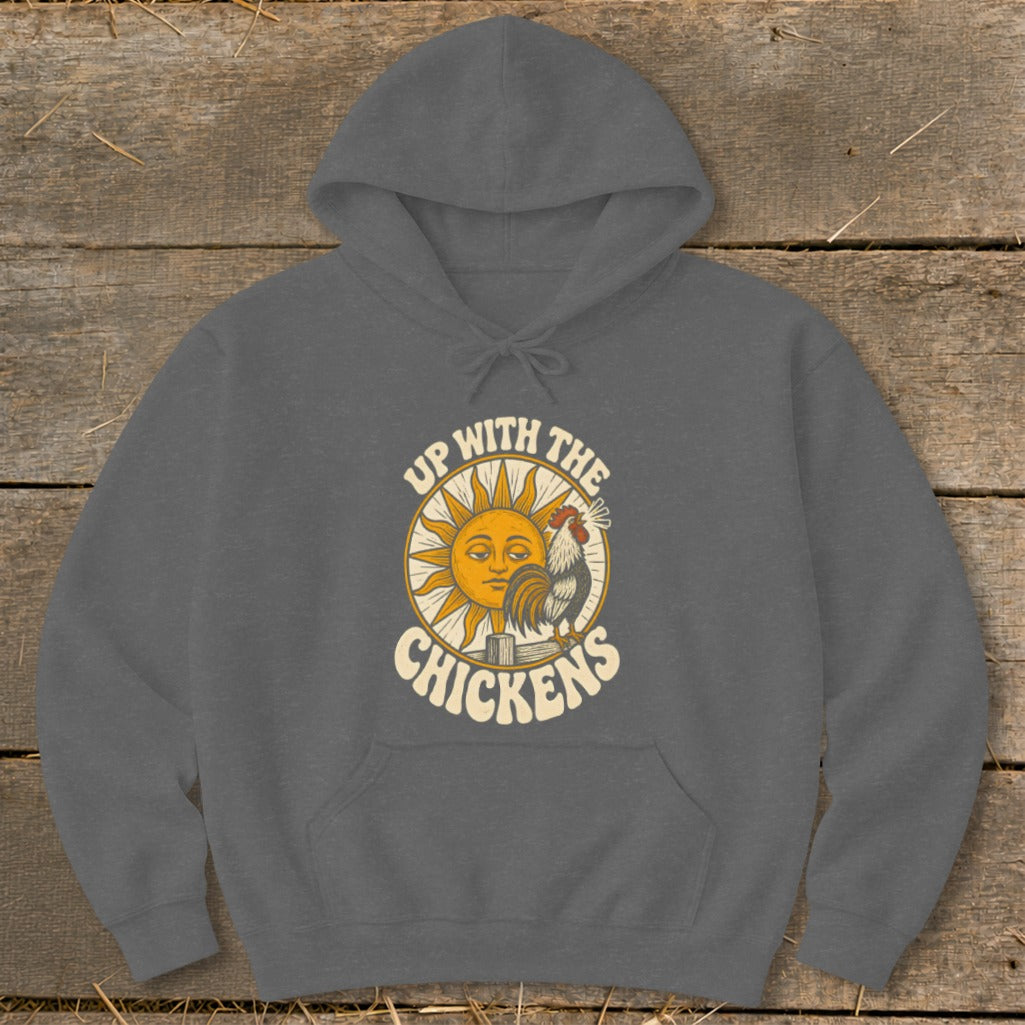 A dark gray hooded sweatshirt featuring a retro graphic of a sun, a rooster, and the text Up With The Chickens.