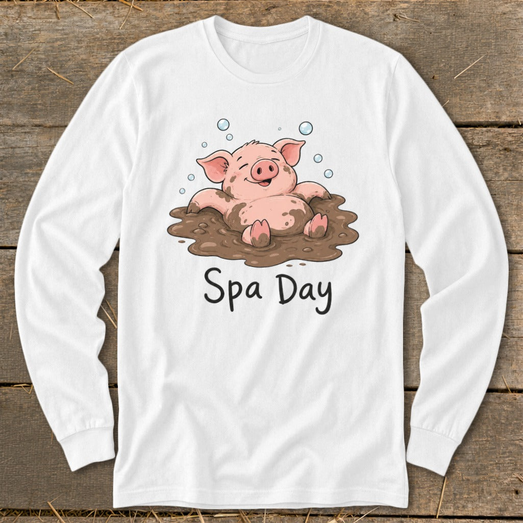 White long-sleeve shirt with cartoon pig relaxing in mud with "Spa Day" text.