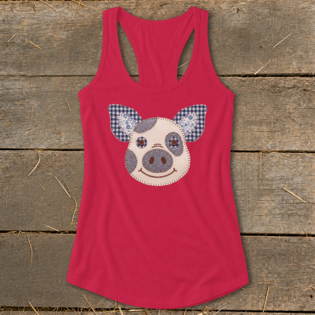 Pink racerback tank top with a stitched pig face applique.