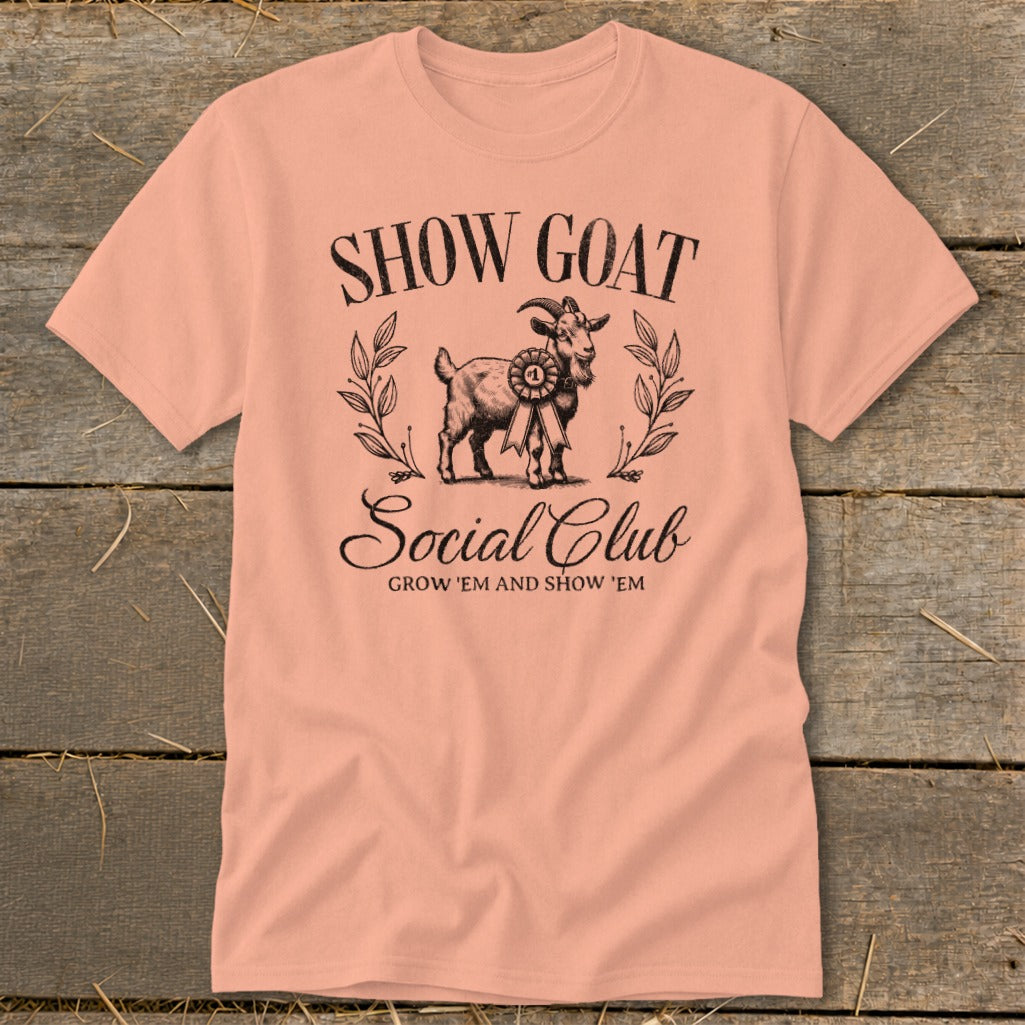 Peach t-shirt with "SHOW GOAT Social Club GROW 'EM AND SHOW 'EM" text and goat graphic.