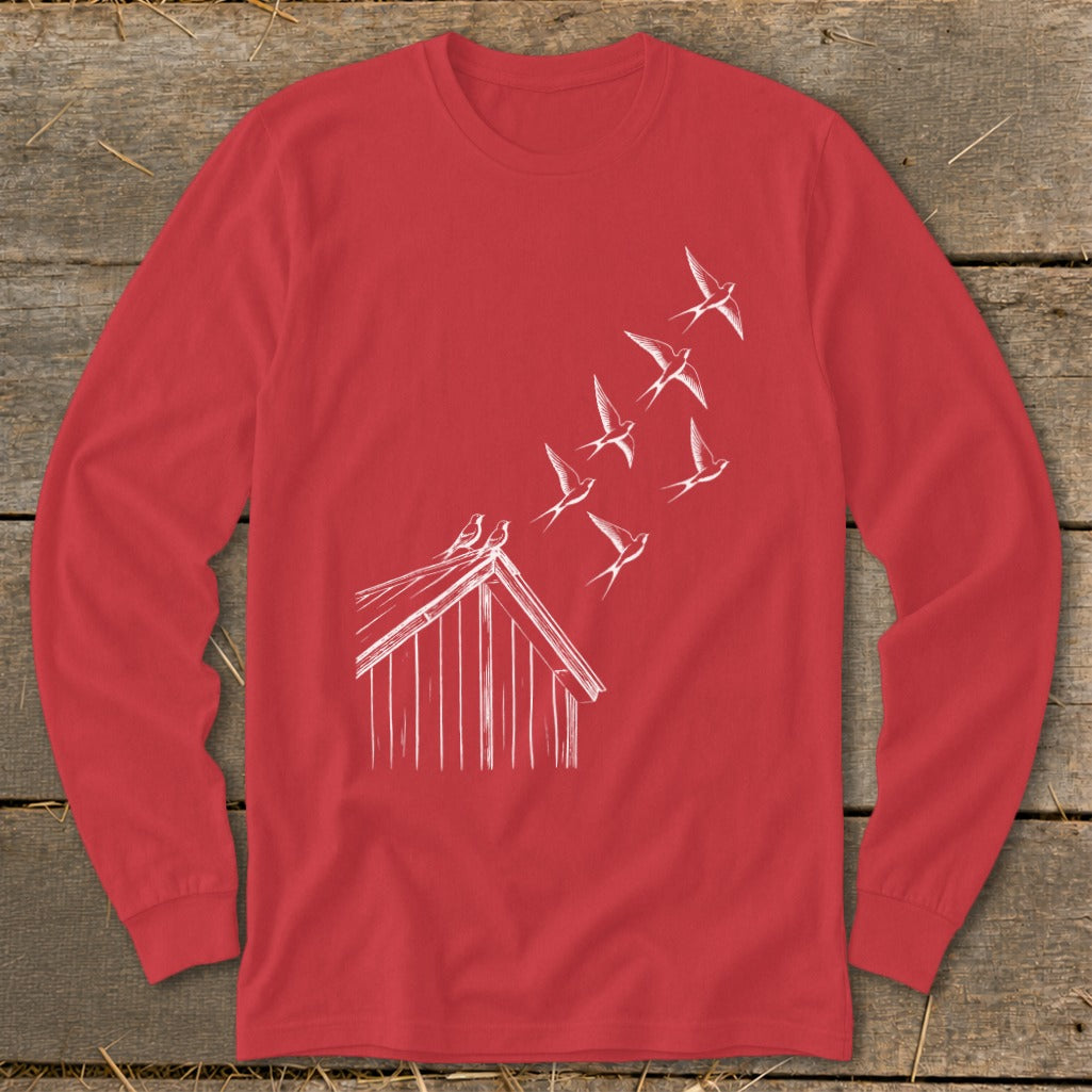 A red long-sleeve t-shirt with a white line drawing of birds flying from a barn roof.