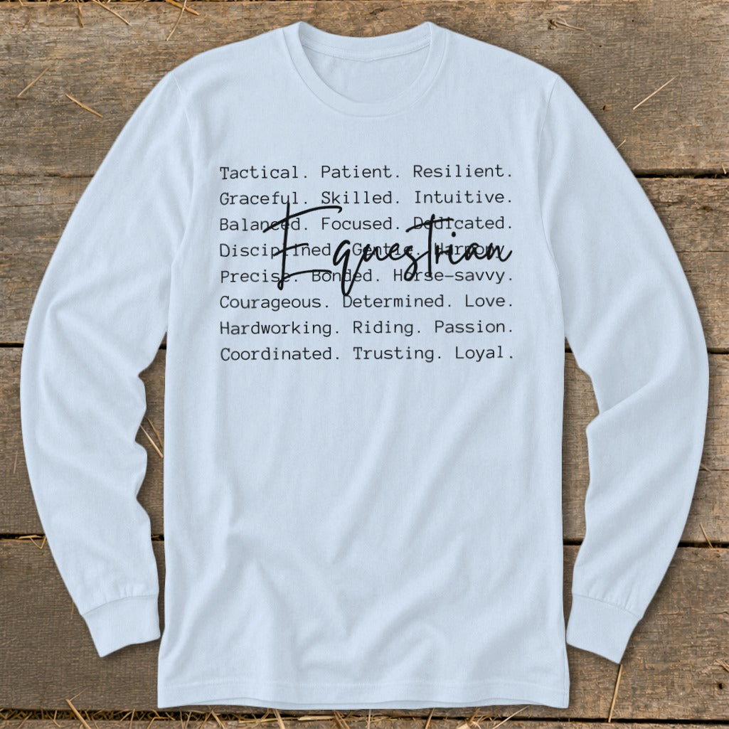 White long-sleeve shirt with list of qualities: Tactical, Patient, Resilient, Graceful, Skilled, Intuitive, Balanced, Focused, Dedicated, Disciplined, Bonded, Horse-savvy, Precise, Courageous, Determined, Love, Hardworking, Riding, Passion, Coordinated, Trusting, Loyal.
