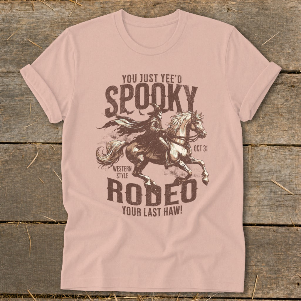 Pink t-shirt with spooky Western style rodeo graphic and text.