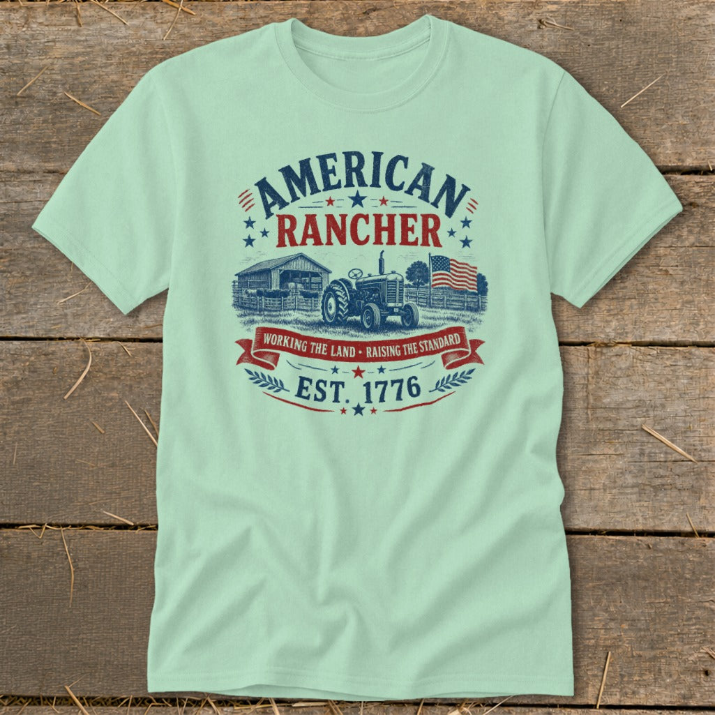 American Rancher t-shirt with tractor, barn, and American flag graphic, EST. 1776.