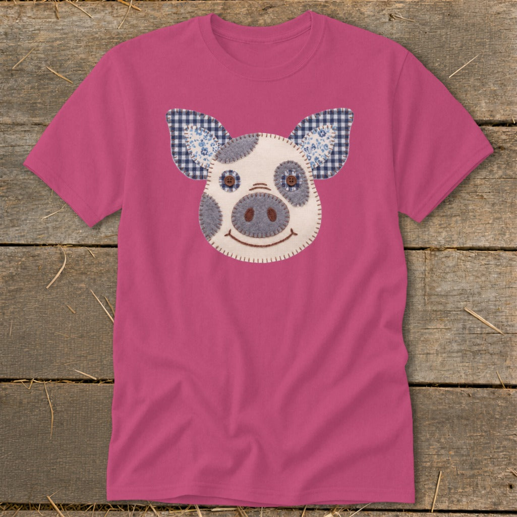 Pink t-shirt with a plush pig face applique on the front.