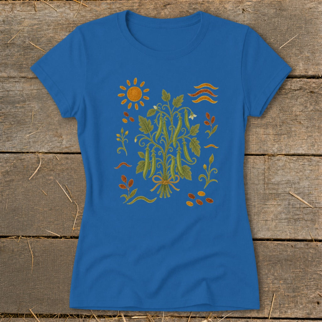 Blue t-shirt with a central embroidered garden design featuring pea pods, sun, and leaves.