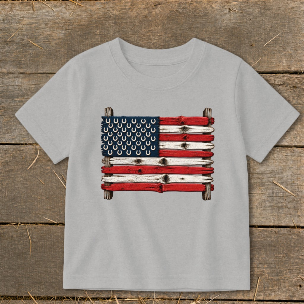 Light gray t-shirt featuring a rustic American flag made of weathered wood and horseshoes centered on the chest.