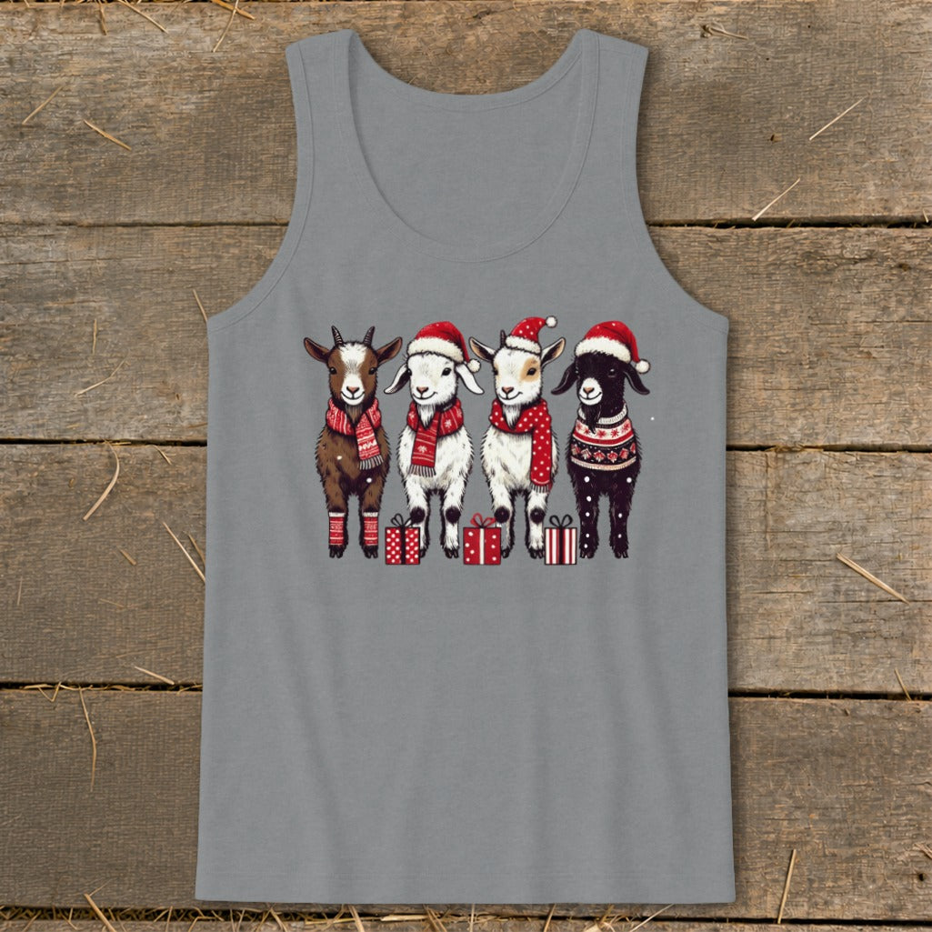 Four goats in Santa hats and scarves stand near gifts.