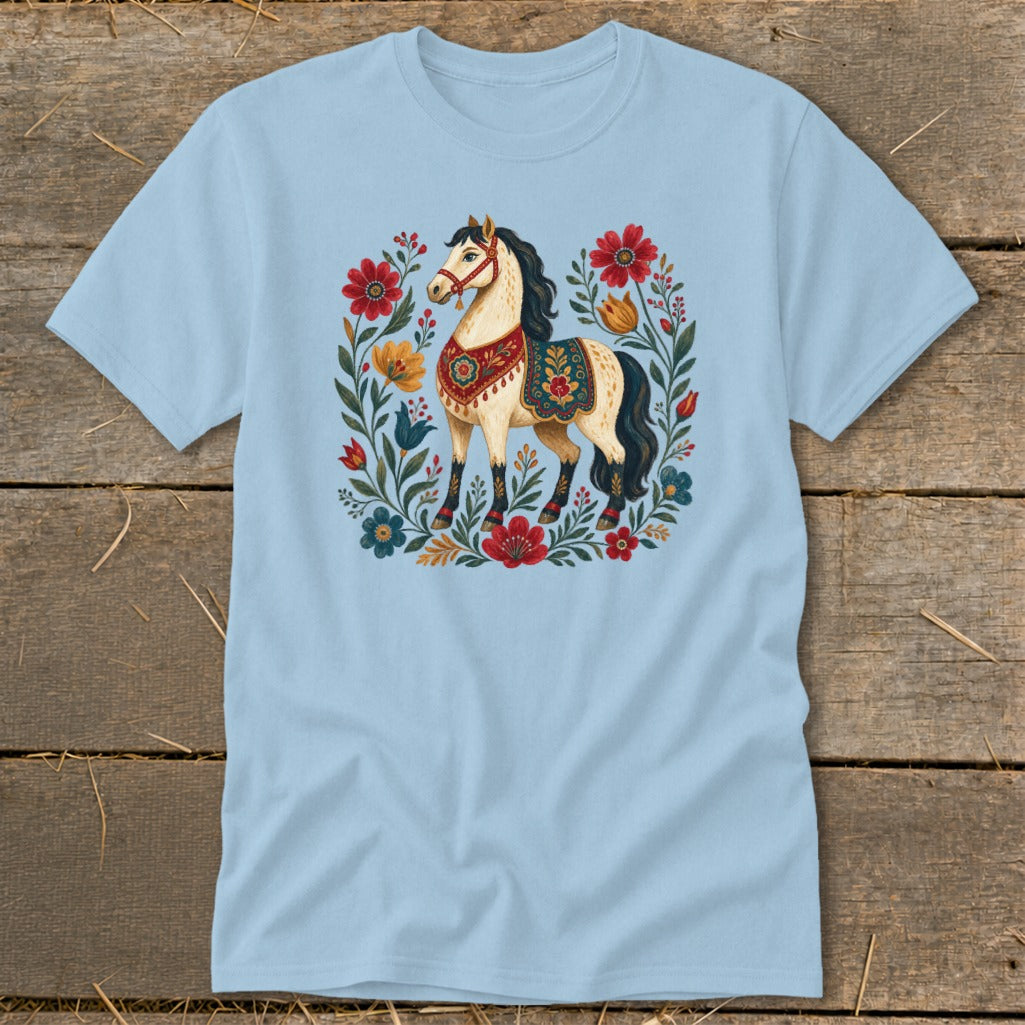 Light blue t-shirt with a cream horse surrounded by red and blue flowers.