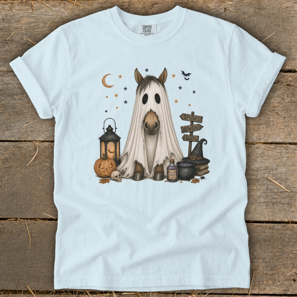 Horse wearing ghost costume with spooky Halloween decorations.