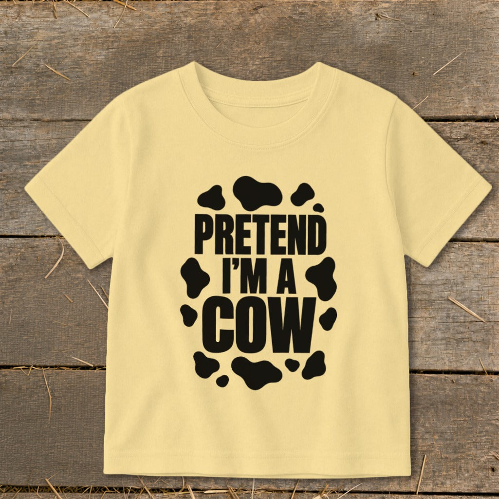 Yellow t-shirt with black "PRETEND I'M A COW" text and cow spots.