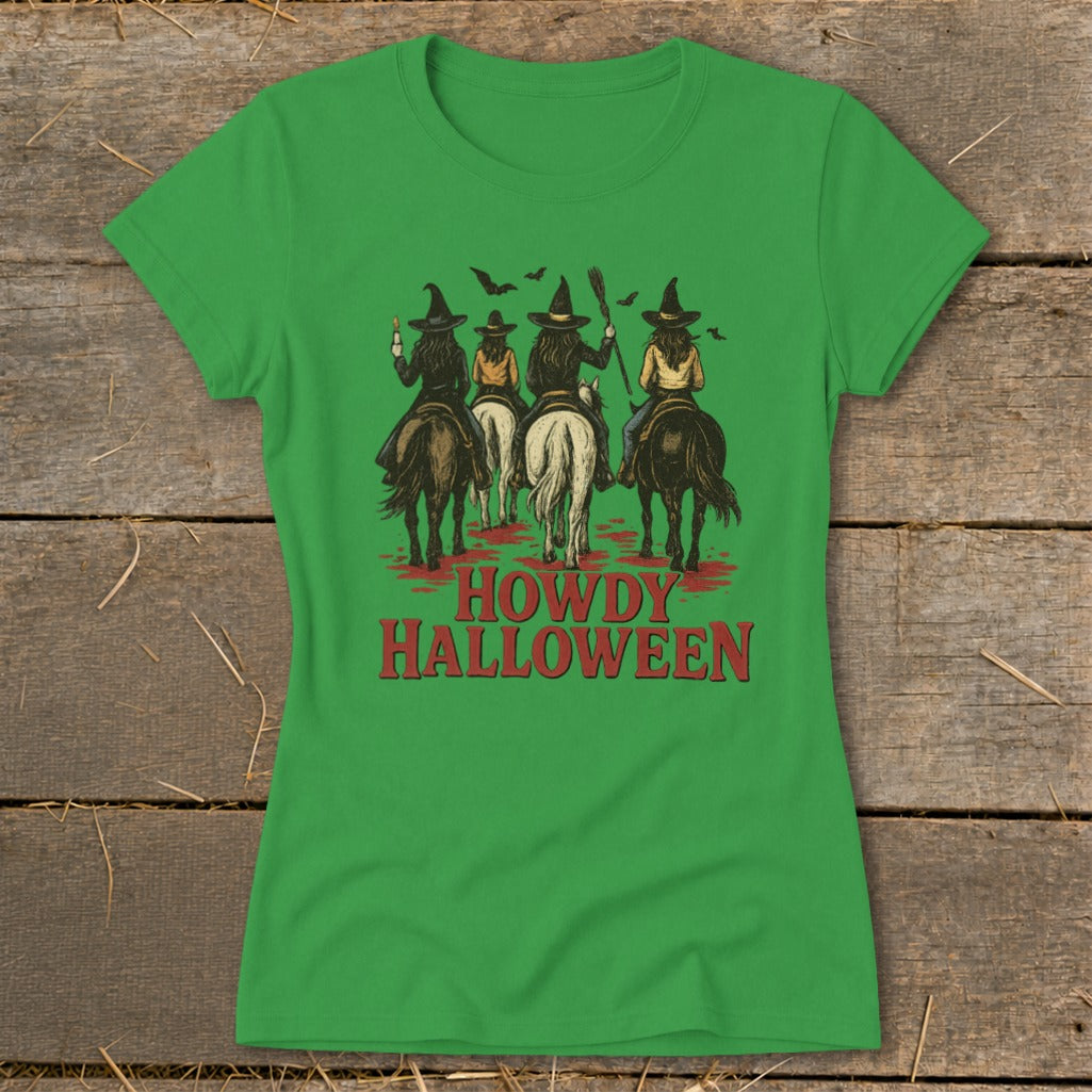 Green t-shirt with four witches on horses and "HOWDY HALLOWEEN" text.