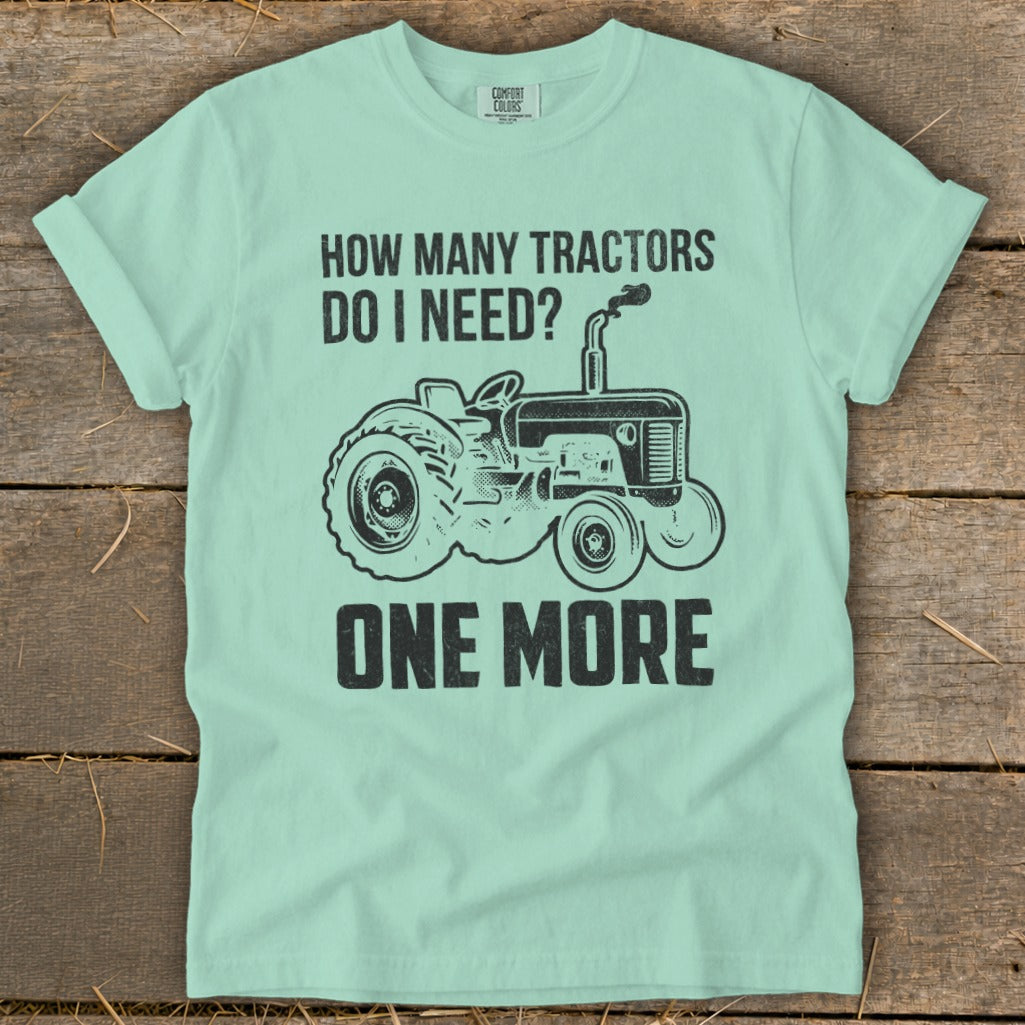 Mint green t-shirt with black text and tractor graphic: "How Many Tractors Do I Need? One More."