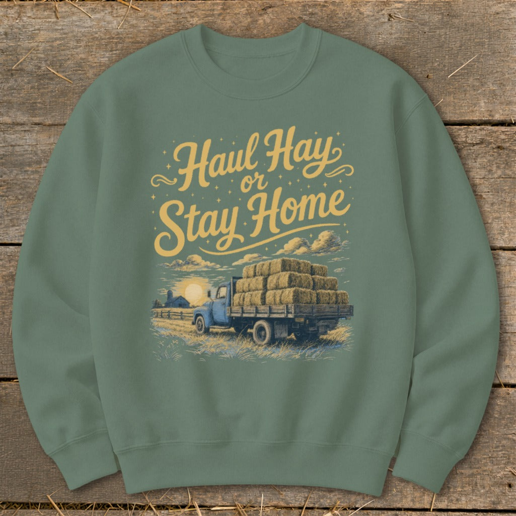 Green sweatshirt with "Haul Hay or Stay Home" text over a blue truck loaded with hay bales.