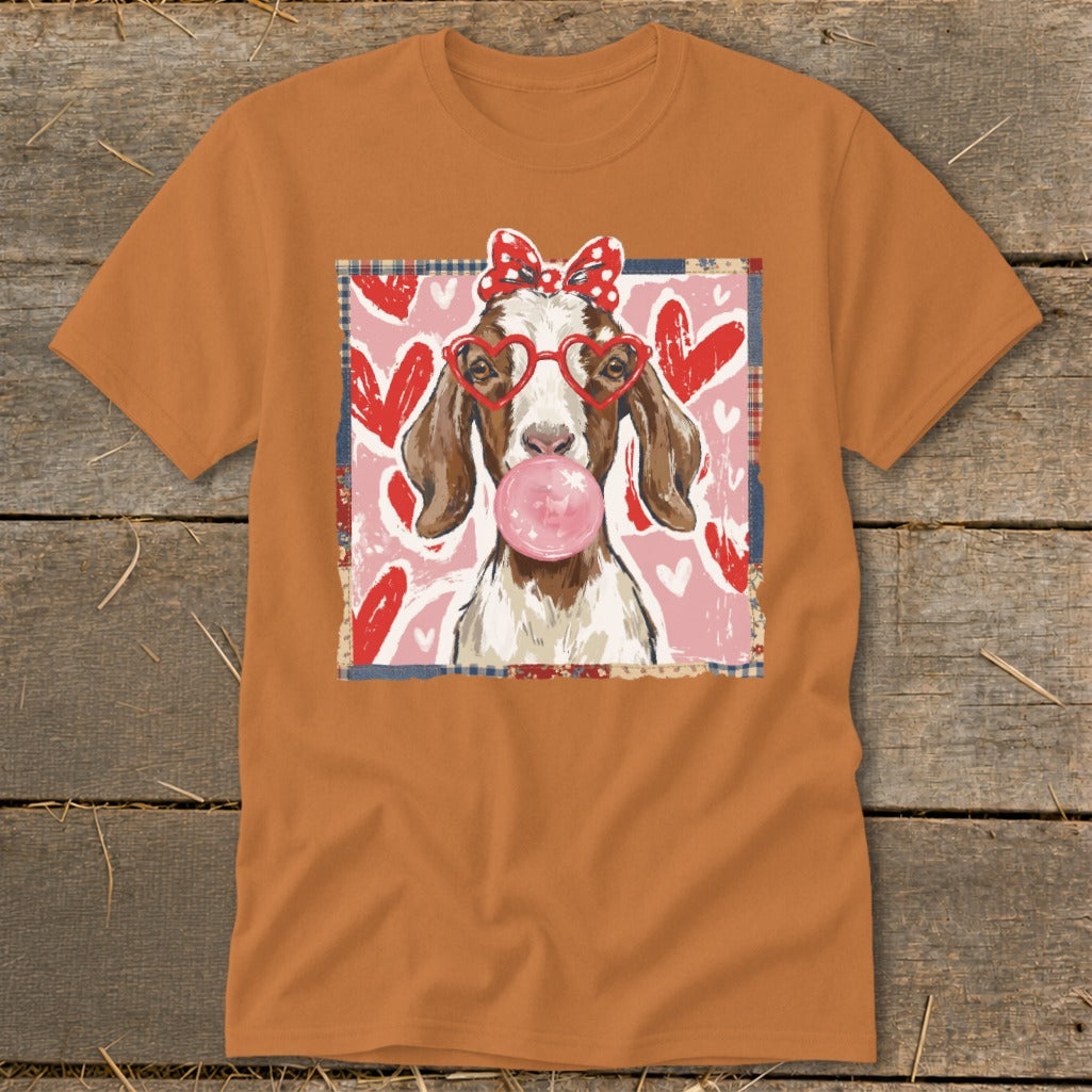 Goat wearing heart glasses and red polka dot bow blowing pink bubblegum.