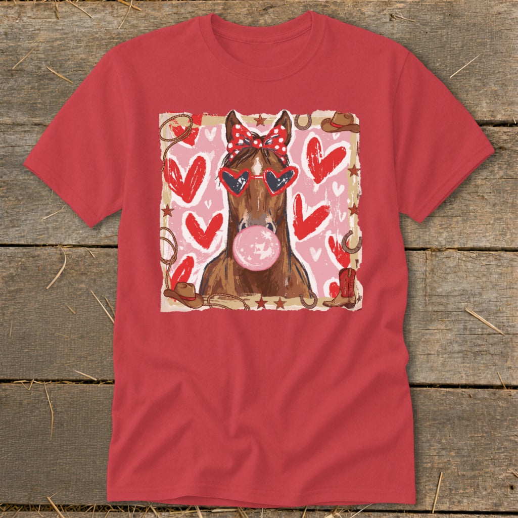 Horse wearing heart sunglasses and polka dot bow, blowing bubblegum, surrounded by hearts and western motifs.